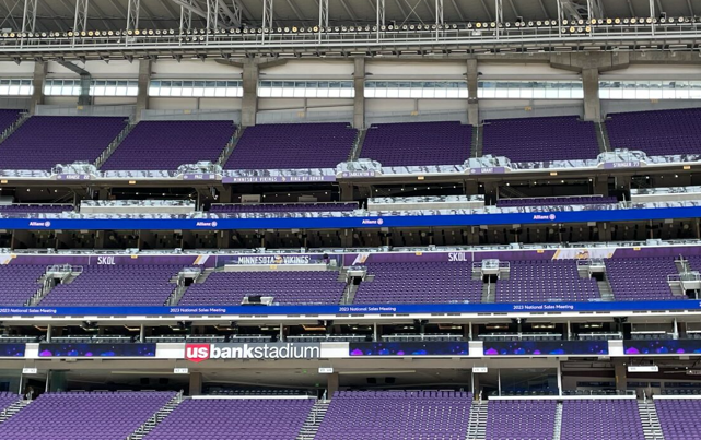 The bleachers at U.S. Bank Stadium, an event venue for ACP's CLEANPOWER Conference 2024. The bleachers are full of purple seats.